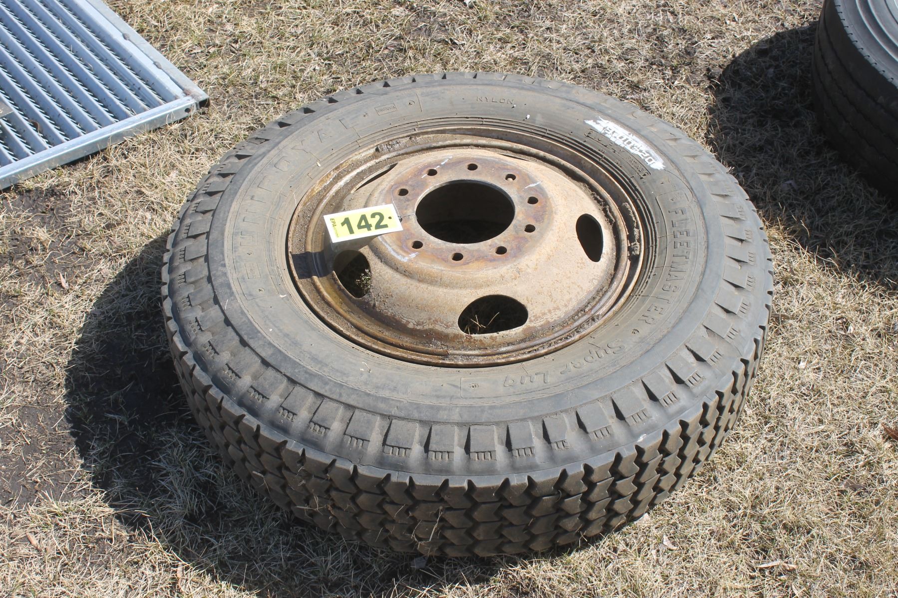 2 10.0020 truck tires & rims, 1 9.0020 truck tire and rim