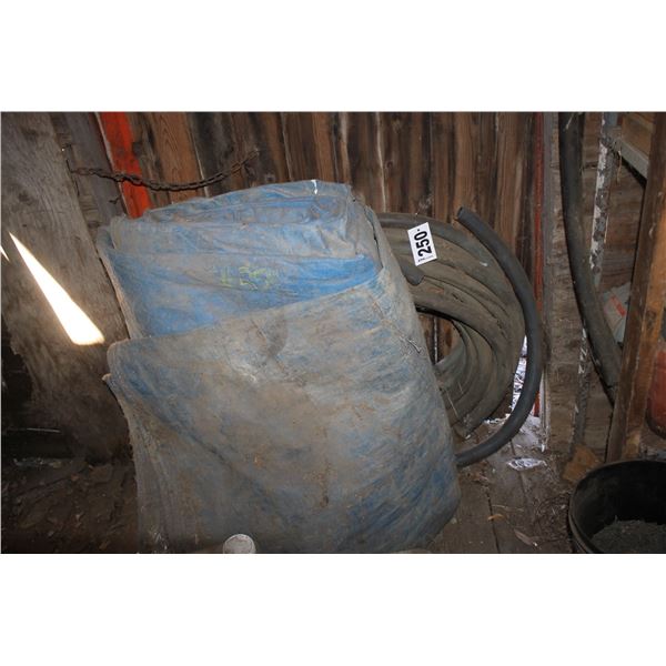 Blue tarp, assorted chemical and roll of heavy fuel hose