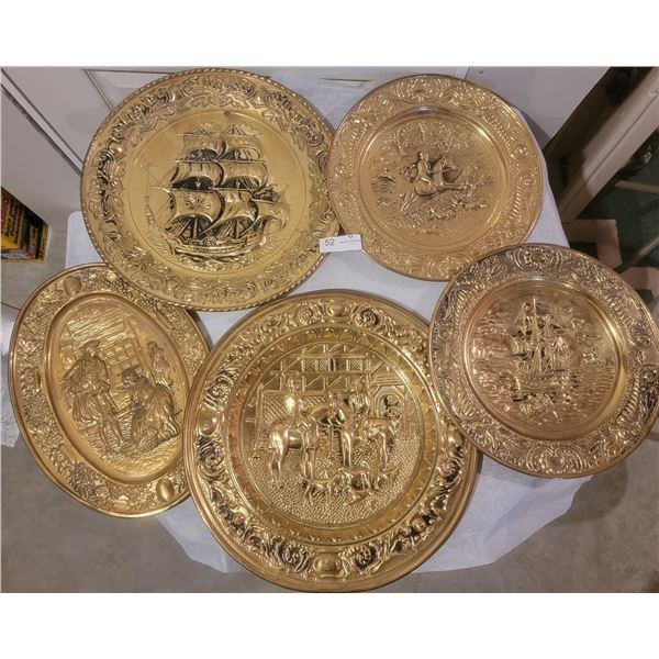 An Assortment Of Decorative Brass Colored Wall Plates