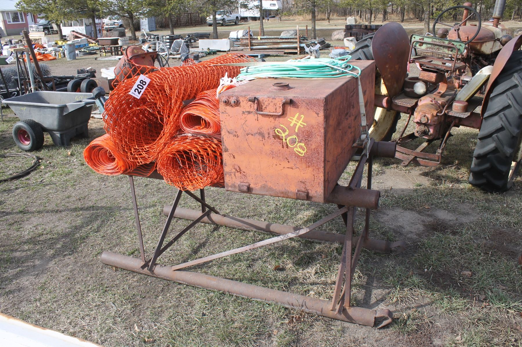 Red square tank, snow fence on a pipe skid rack
