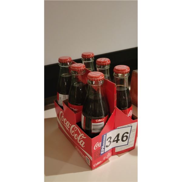 6 pack of Coca Cola, glass bottle, full