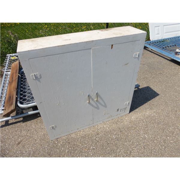 Chain-link gate & white cupboard