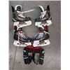 Image 1 : Two pairs of youth Bauer/CCM hockey skates and pair of gloves with 7 mini hockey stix