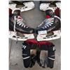 Image 2 : Two pairs of youth Bauer/CCM hockey skates and pair of gloves with 7 mini hockey stix