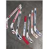 Image 4 : Two pairs of youth Bauer/CCM hockey skates and pair of gloves with 7 mini hockey stix