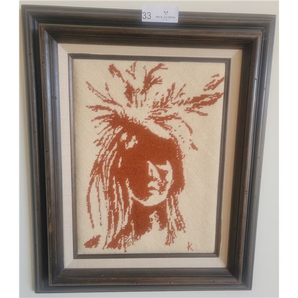 A Framed Picture Of A Cross Stitched Native American Man