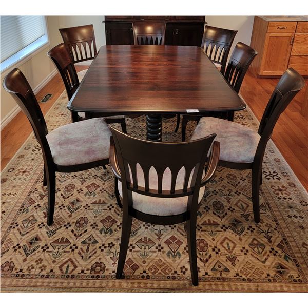 An Wooden Dining Room Table, Complete With 8 Chairs And 2 Leaves