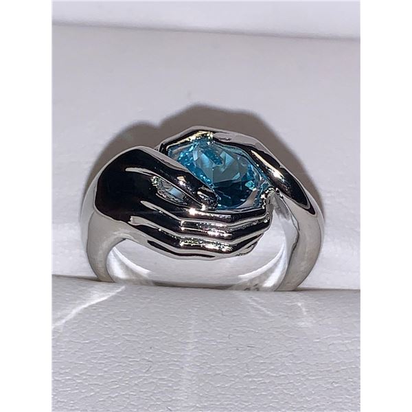 Ladies Blue Topaz Solitaire Gem in Hands .925 Silver Ring