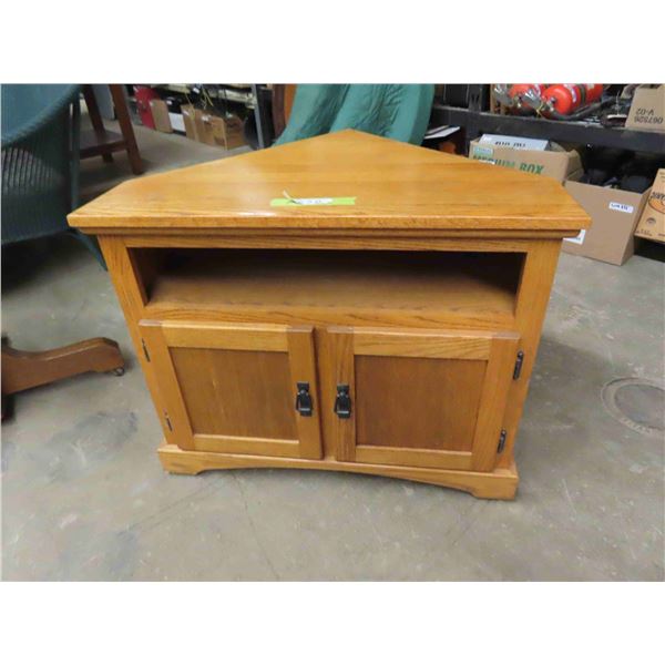 Corner T.V. Cabinet in Mission Oak.  Very well made.  It is 34.5”at front x 25”  front 