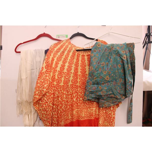 Assorted colored scarves, large orange shirt, blue floral wrap around skirt