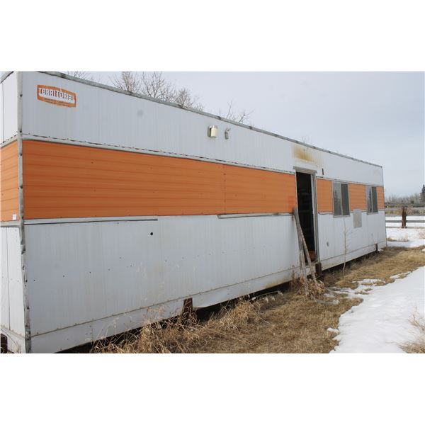 Territorial Skid Trailer, approx. 10' x 48', missing 1- door, mounted on heavy skid. (Buyer responsi