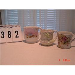 (3) MUGS - 1-white with raised green leaves, 1-violets, 1-pink with ivy