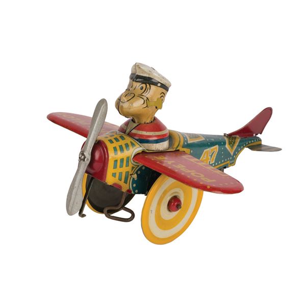 A Popeye the Pilot Wind-Up Tin Toy.