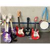 Image 1 : Group of assorted kids' guitar toys w/ drum & stick