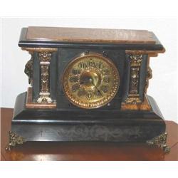 Antique mantel clock finished in black w/faux burl trimmed in brass - key wound - dates from the tur