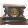 Image 1 : Antique mantel clock finished in black w/faux burl trimmed in brass - key wound - dates from the tur
