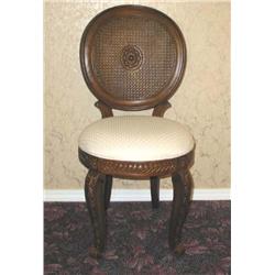 Round-backed desk chair w/double cain & a center medallion in carved fruitwood upholstered in cream 