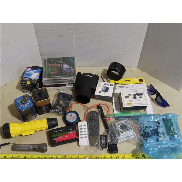 Assorted household items: Flashlights, batteries, Nikon Camera accessories, Brand new DVD player, et