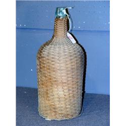 GLASS BOTTLE ENCASED IN WICKER