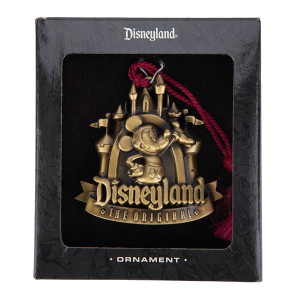 A Brass Mickey and Castle Ornament in the Box.