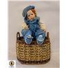 PORCELAIN DOLL IN BASKET