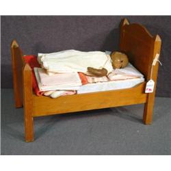 DOLL'S BED WITH BEDDING AND DOLL