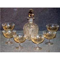 CUT GLASS CRUET WITH ETCHED CHAMPAGNES