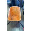 Image 2 : Orange plastic wheelbarrow.