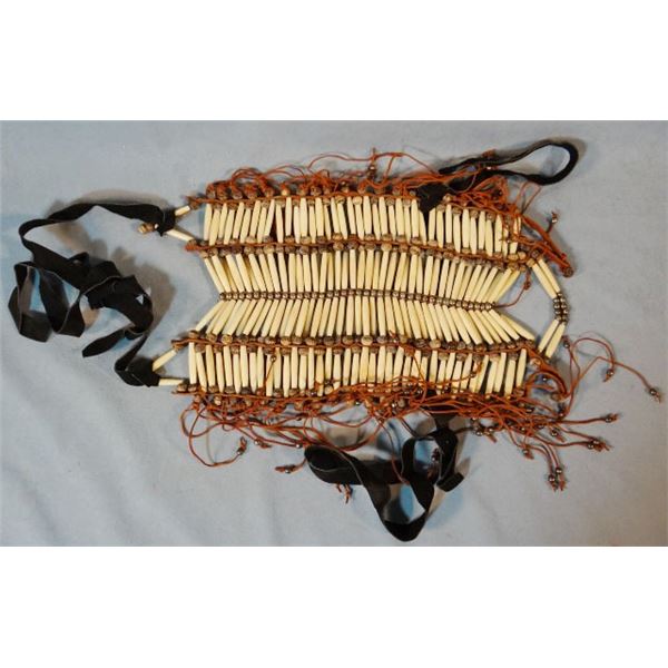 Indian breast plate, hair pipe and tiny bells with leather fringe, newer