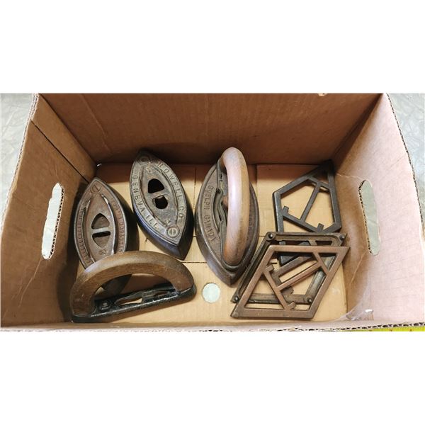 Box of vintage clothing irons