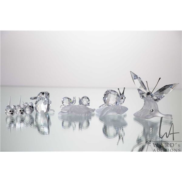 Seven small Swarovski crystal insects including butterfly, snails, and ...