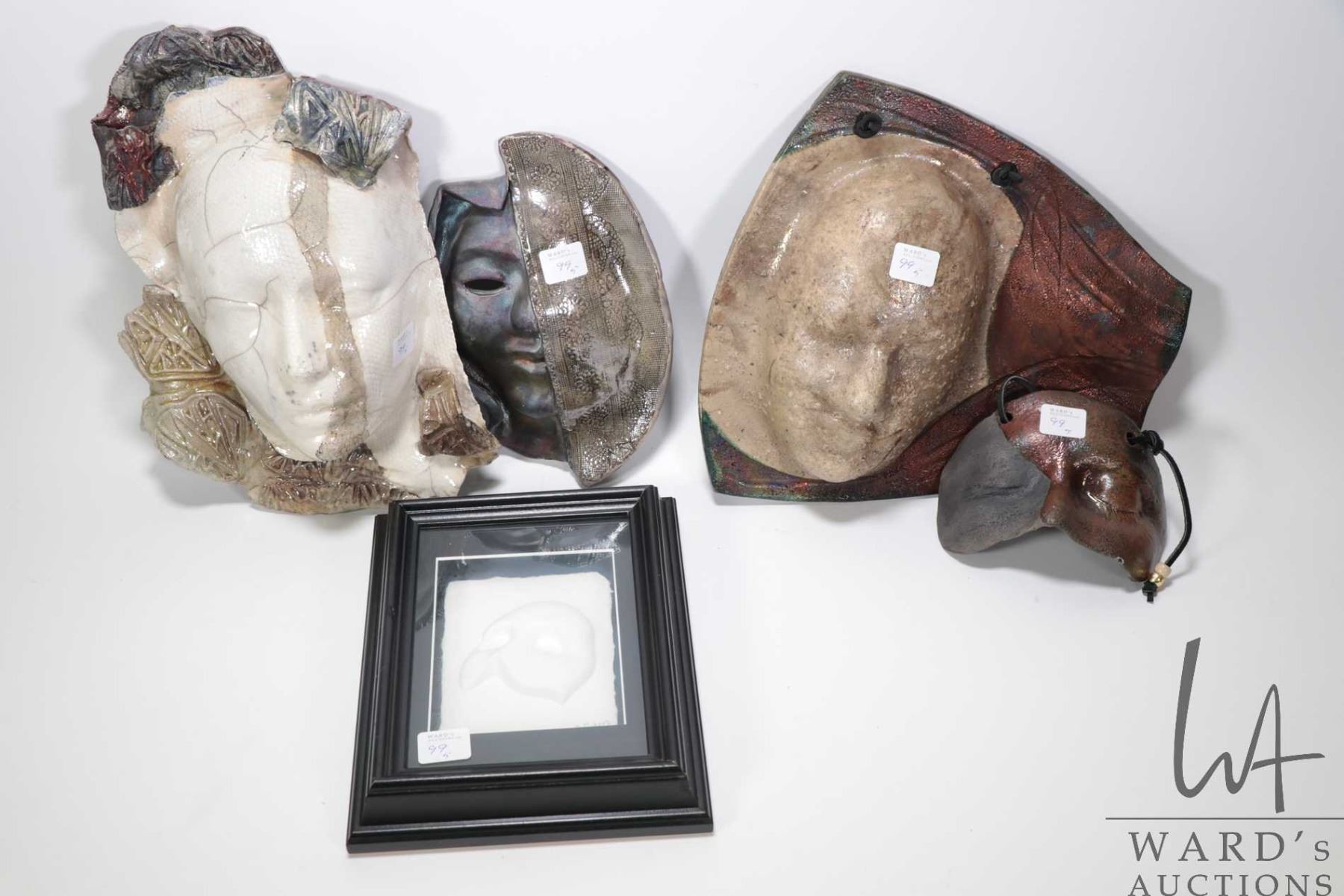 Four clay wall masks including porcelain raku and a framed cast paper ...
