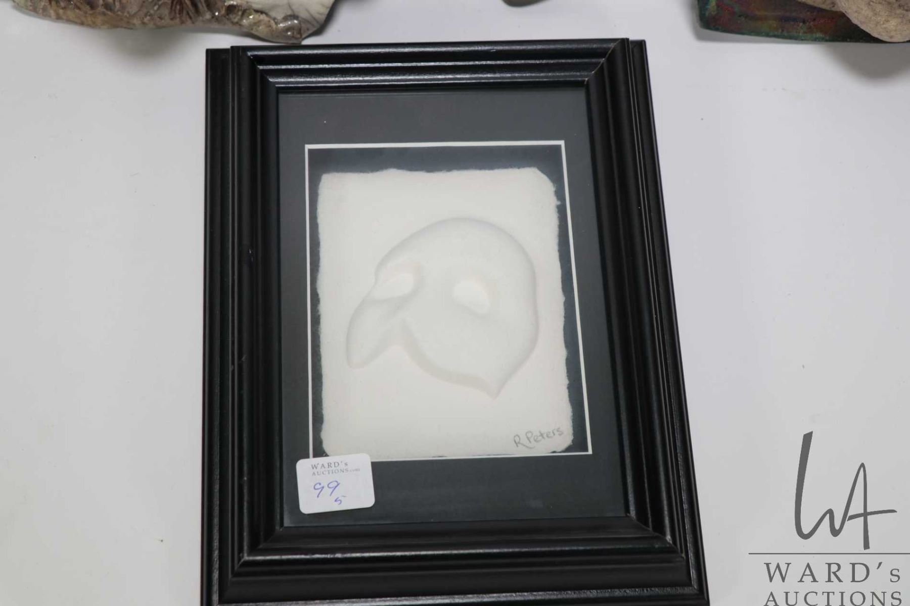 Four clay wall masks including porcelain raku and a framed cast paper ...