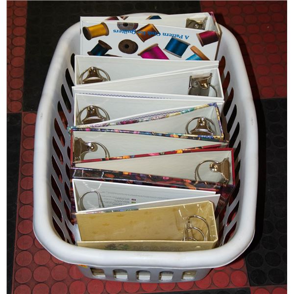 LAUNDRY BASKET FULL OF LARGE BINDERS Laundry basket full of large binders