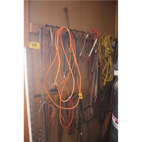Misc. cords, chains, bars, rope etc. hanging on the wall