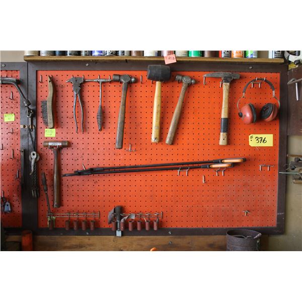 Misc. on orange peg board. Hammers, fencing tools and cans above