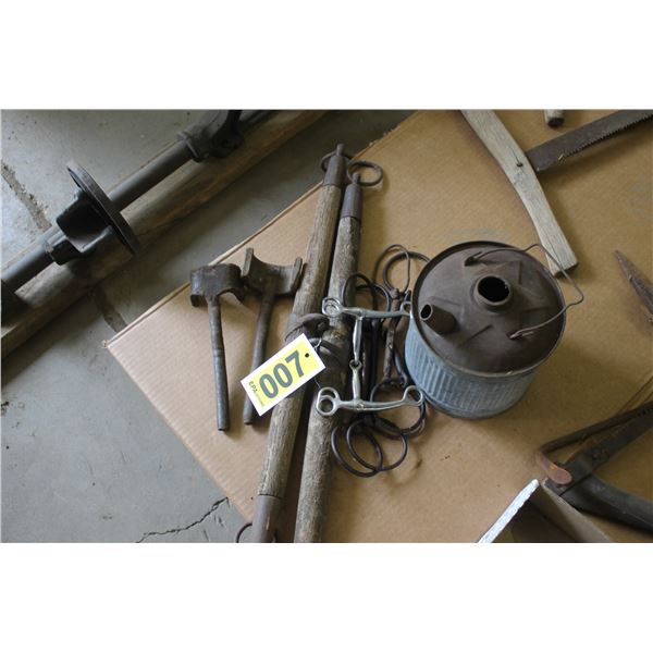 Horse bits, gas can, wagon wheel wrenches.