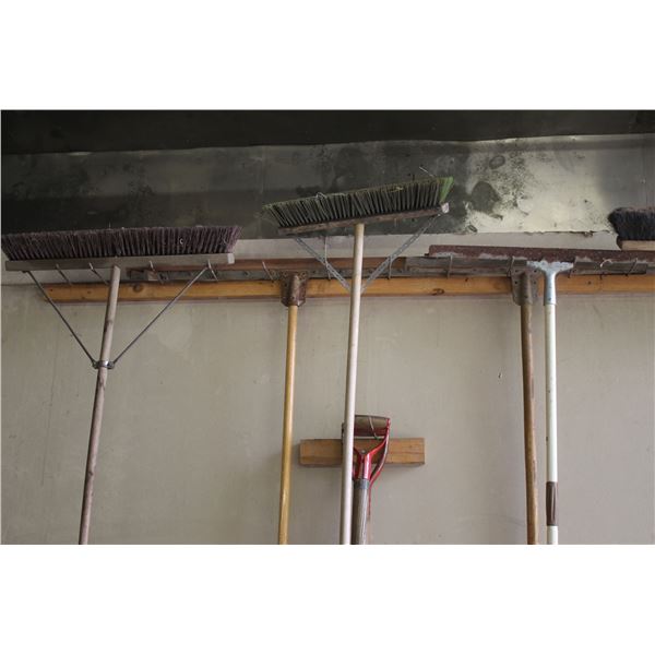 3  squeegees and 5 shop brooms