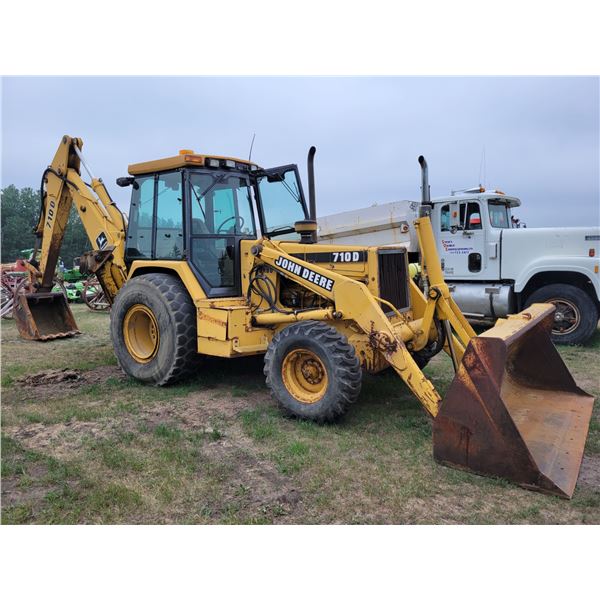 JD 710D Backhoe Turbo, 92" Bucket, 28" digging bucket, Frt 12.5x18's (V.G.), Rear 20.5 R25, Showing