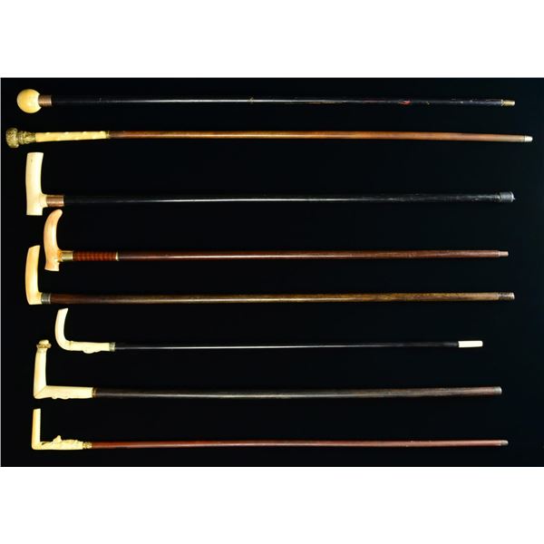 GROUP OF EIGHT VINTAGE CANES AND WALKING STICKS.