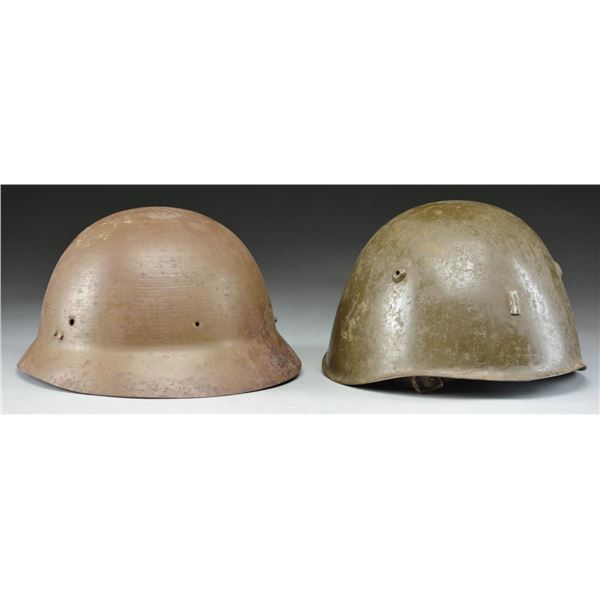 2 WWII ERA HELMETS.