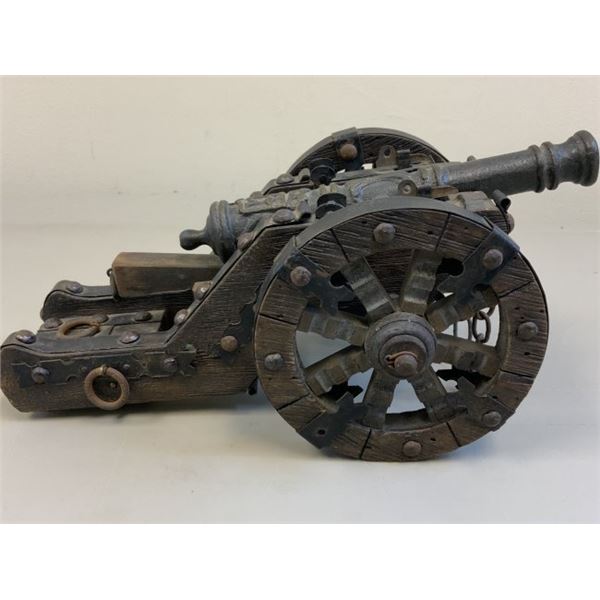 ANTIQUE MODEL OF A BRASS CANNON WITH WOODEN WHEELS