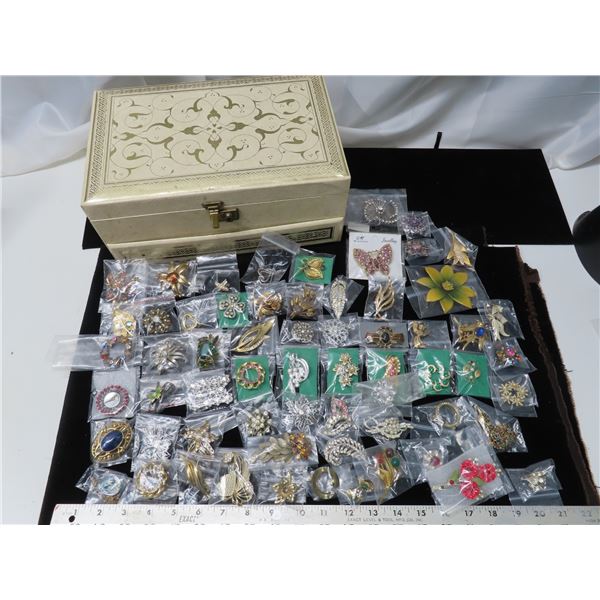 Large Jewelry box with large allotment of broaches