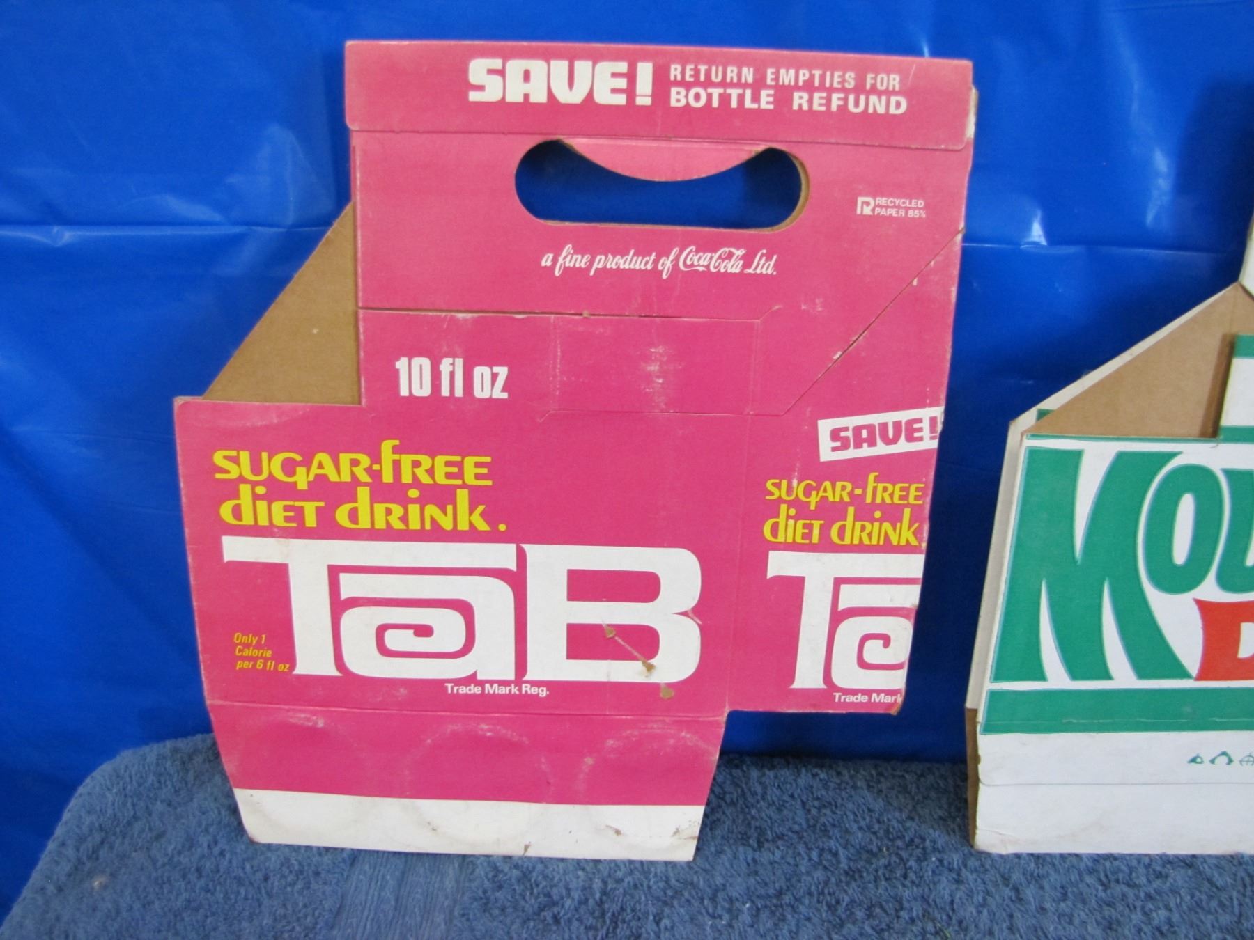 Collection of cardboard carrying cases Mountain Dew, C plus, tab