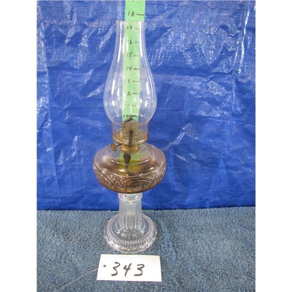 Vintage oil Lamp with glass base has some oil in it