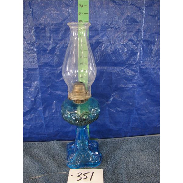 Vintage oil lamp with blue bullseye pattern glass base