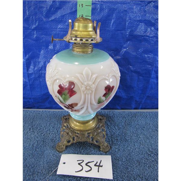 Vintage oil lamp with cast base probably hand painted flowers no glass chimney And burner is detache