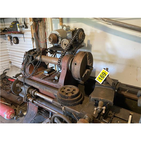 Old Lathe c/w Extra chucks & tooling c/w 5 Hp motor (works) Can be Loaded July 17th between 4 & 5 pm