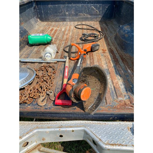 Chain, weed eater & misc. on back of ford