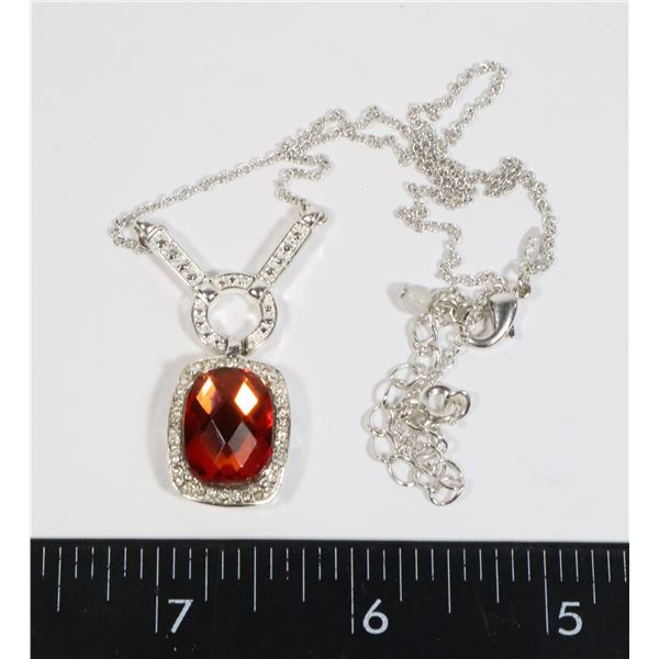 RHINESTONE PENDANT CENTERED BY ORANGE STONE ON